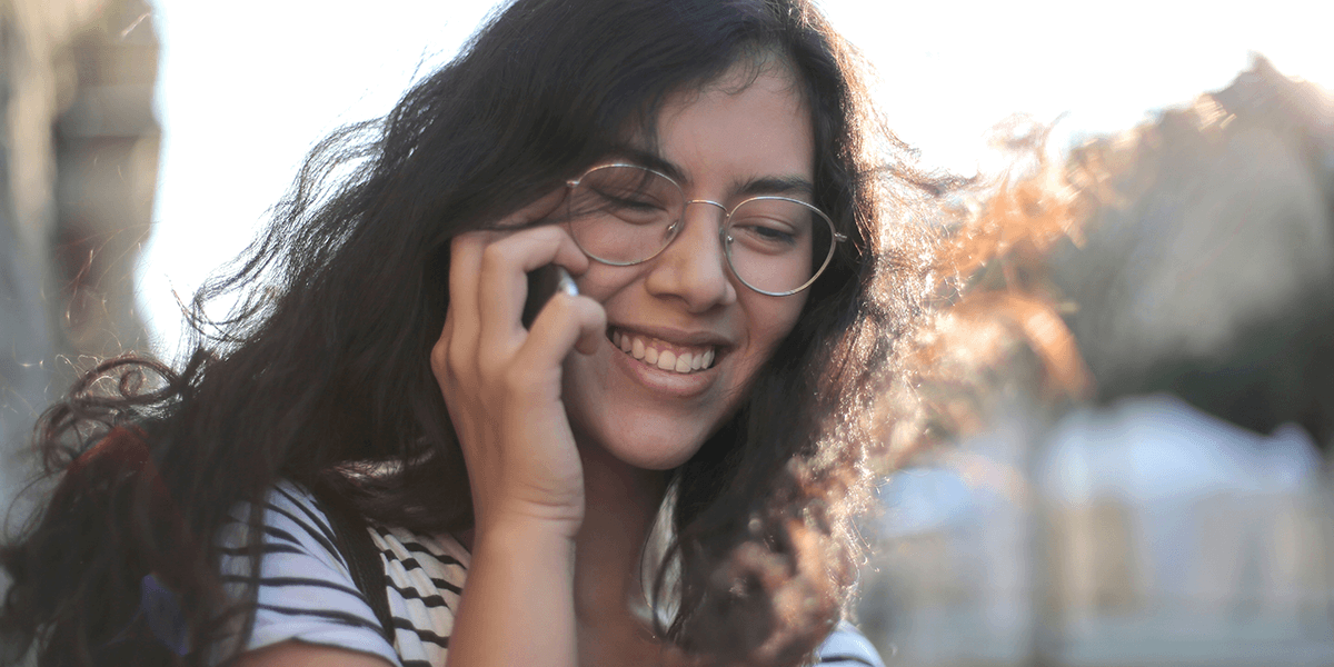 Microsoft Power Automate Premium Connectors Image of someone smiling on the phone 