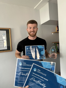 valto employee with awards and trophy