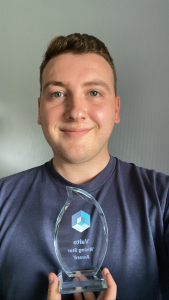 valto employee with trophy